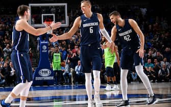 DALLAS, TX - DECEMBER 4: Luka Doncic #77, and Kristaps Porzingis #6 of the Dallas Mavericks hi-five each other against the Minnesota Timberwolves on December 04, 2019 at the American Airlines Center in Dallas, Texas. NOTE TO USER: User expressly acknowledges and agrees that, by downloading and or using this photograph, User is consenting to the terms and conditions of the Getty Images License Agreement. Mandatory Copyright Notice: Copyright 2019 NBAE (Photo by Glenn James/NBAE via Getty Images)