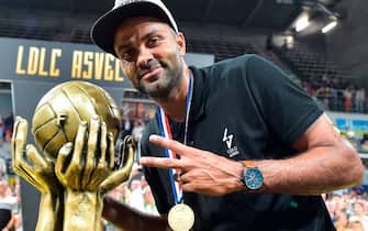 Lyon-Villeurbanne's French President Tony Parker poses next to the trophy as he celebrates after his team won the 5th leg of the French Elite championship final basketball match between Monaco (AS Monaco) and Lyon-Villeurbanne (ASVEL) at the Astroballe arena in Villeurbanne, on June 25, 2019. (Photo by ROMAIN LAFABREGUE / AFP)        (Photo credit should read ROMAIN LAFABREGUE/AFP via Getty Images)