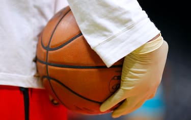 ATLANTA, GA - MARCH 09:  Ballboys wear gloves while handling warmup basketballs as a precautionary measure prior to an NBA game between the Charlotte Hornets and Atlanta Hawks at State Farm Arena on March 9, 2020 in Atlanta, Georgia. NOTE TO USER: User expressly acknowledges and agrees that, by downloading and/or using this photograph, user is consenting to the terms and conditions of the Getty Images License Agreement. (Photo by Todd Kirkland/Getty Images) *** Local Caption *** 