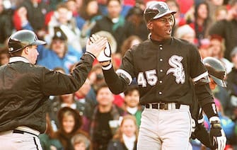 CHICAGO, IL - APRIL 7:  Chicago White Sox outfielder Michael Jordan (R) is greeted by a unidentified batboy at Chicago's Wrigley Field, 07 April 1994, after scoring on a sixth inning home run during a crosstown exhibition game against the Cubs. Jordan, who will return to the minor leagues after the game, had two hits as the teams tied 4-4.  (Photo credit should read EUGENE GARCIA/AFP via Getty Images)