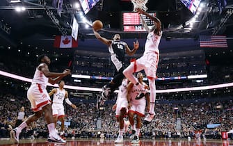 TORONTO, ON - JANUARY 12:  DeMar DeRozan #10 of the San Antonio Spurs dunks the ball on Chris Boucher #25 of the Toronto Raptors defends during the second half of an NBA game at Scotiabank Arena on January 12, 2020 in Toronto, Canada.  NOTE TO USER: User expressly acknowledges and agrees that, by downloading and or using this photograph, User is consenting to the terms and conditions of the Getty Images License Agreement.  (Photo by Vaughn Ridley/Getty Images)