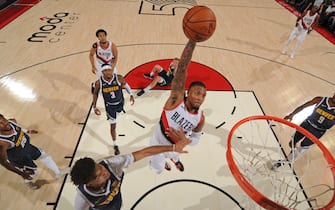 PORTLAND, OR - OCTOBER 23: Damian Lillard #0 of the Portland Trail Blazers dunks the ball against the Denver Nuggets on October 23, 2019 at the Moda Center Arena in Portland, Oregon. NOTE TO USER: User expressly acknowledges and agrees that, by downloading and or using this photograph, user is consenting to the terms and conditions of the Getty Images License Agreement. Mandatory Copyright Notice: Copyright 2019 NBAE (Photo by Cameron Browne/NBAE via Getty Images)