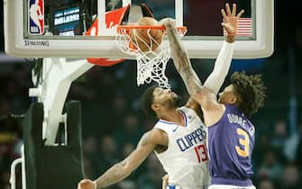 1189409847 LOS ANGELES, CA - DECEMBER 17: Kelly Oubre Jr. #3 of the Phoenix Suns dunks the ball over Paul George #13 of the LA Clippers on December 17, 2019 at STAPLES Center in Los Angeles, California. NOTE TO USER: User expressly acknowledges and agrees that, by downloading and/or using this Photograph, user is consenting to the terms and conditions of the Getty Images License Agreement. Mandatory Copyright Notice: Copyright 2019 NBAE (Photo by Chris Elise/NBAE via Getty Images)
