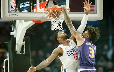LOS ANGELES, CA - DECEMBER 17: Kelly Oubre Jr. #3 of the Phoenix Suns dunks the ball over Paul George #13 of the LA Clippers on December 17, 2019 at STAPLES Center in Los Angeles, California. NOTE TO USER: User expressly acknowledges and agrees that, by downloading and/or using this Photograph, user is consenting to the terms and conditions of the Getty Images License Agreement. Mandatory Copyright Notice: Copyright 2019 NBAE (Photo by Chris Elise/NBAE via Getty Images)
