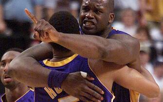 PORTLAND, UNITED STATES:  The Los Angeles Lakers Shaquille O'Neal (R) celebrates with teammate Robert Horry after Horry hit a three pointer to defeat the Portland Trail Blazers in Portland, Oregon, 28 April, 2002, during the second half of game three in the first round of the NBA Western Conference Playoffs. The Lakers won the best-of-five series 3-0. AFP Photo/John Gress (Photo credit should read JOHN GRESS/AFP via Getty Images)
