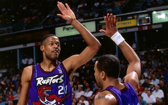 461684375 SACRAMENTO, CA - MARCH 3: Marcus Camby #21 and Damon Stoudamire #20 of the Toronto Raptors high five each other during a game played on March 3, 1997 at Arco Arena in Sacramento, California. NOTE TO USER: User expressly acknowledges and agrees that, by downloading and or using this photograph, User is consenting to the terms and conditions of the Getty Images License Agreement. Mandatory Copyright Notice: Copyright 1997 NBAE (Photo by Rocky Widner/NBAE via Getty Images)