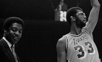 (Original Caption) Oscar Robertson (l) congratulates Los Angeles Lakers' Kareem Abdul-Jabbar, who broke Robertson's record for the second highest scorer in the NBA 12/1 against the Utah Jazz at the Inglewood Forum. Abdul-Jabbar's 14 points tonight put him 8 ahead of Robertson, with 26, 718. The game was stopped and Robertson awarded Abdul-Jabbar with the game ball.