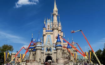 Workers at Walt Disney World paint Cinderella Castle in the Magic Kingdom, in Lake Buena Vista, Fla., on March 12, 2020. (Joe Burbank/Orlando Sentinel/Tribune News Service via Getty Images)