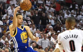PORTLAND, OR - MAY 9: Stephen Curry #30 of the Golden State Warriors looks to pass the ball as Damian Lillard #0 of the Portland Trail Blazers defends during the first quarter of Game Four of the Western Conference Semifinals during the 2016 NBA Playoffs at the Moda Center on May 9, 2016 in Portland, Oregon. NOTE TO USER: User expressly acknowledges and agrees that by downloading and/or using this photograph, user is consenting to the terms and conditions of the Getty Images License Agreement.  (Photo by Steve Dykes/Getty Images)