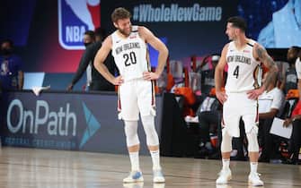 ORLANDO, FL - JULY 25: Nicolo Melli #20 shares a laugh with JJ Redick #4 of the New Orleans Pelicans during the game on July 25, 2020 at HP Field House at ESPN Wide World of Sports Complex in Orlando, Florida. NOTE TO USER: User expressly acknowledges and agrees that, by downloading and or using this photograph, User is consenting to the terms and conditions of the Getty Images License Agreement. Mandatory Copyright Notice: Copyright 2020 NBAE (Photo by Joe Murphy/NBAE via Getty Images)