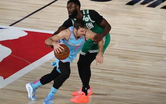 Aug 4, 2020; Lake Buena Vista, Florida, USA; Miami Heat guard Goran Dragic (7) drives against Boston Celtics guard Jaylen Brown (7) in the second half of a NBA basketball game at the Visa Athletic Center in the ESPN Wide World of Sports Complex. Mandatory Credit: Kim Klement-USA TODAY Sports
