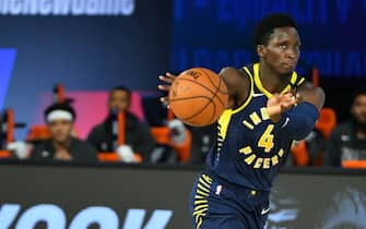 Orlando, FL - JULY 26: Victor Oladipo #4 of the Indiana Pacers passes the ball against the Dallas Mavericks during a scrimmage on July 26, 2020 at HP Field House at ESPN Wide World of Sports in Orlando, Florida. NOTE TO USER: User expressly acknowledges and agrees that, by downloading and/or using this Photograph, user is consenting to the terms and conditions of the Getty Images License Agreement. Mandatory Copyright Notice: Copyright 2020 NBAE (Photo by Jesse D. Garrabrant/NBAE via Getty Images)