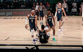 ORLANDO, FL - JULY 27: J.J. Redick #4 is helped up by Josh Hart #3 and Nickiel Alexander-Walker #0 of the New Orleans Pelicans against the Milwaukee Bucks as part of the NBA Restart 2020 on July 27, 2020 at The Arena at ESPN Wide World of Sports Complex in Orlando, Florida. NOTE TO USER: User expressly acknowledges and agrees that, by downloading and/or using this photograph, user is consenting to the terms and conditions of the Getty Images License Agreement.  Mandatory Copyright Notice: Copyright 2020 NBAE (Photo by Jim Poorten/NBAE via Getty Images)