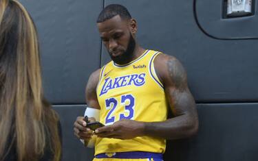 LeBron James checks his cellphone on arrival for his press conference on the Los Angeles Lakers in Los Angeles, California, September 24, 2018, with the Lakers' newest blockbuster signing and teammates met with the media. - The Lakers open their 2018 NBA season in Portland on October 18th. (Photo by Frederic J. BROWN / AFP)        (Photo credit should read FREDERIC J. BROWN/AFP via Getty Images)