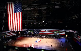LAKE BUENA VISTA, FLORIDA - JULY 30: The America flag is seen as the Los Angeles Lakers and the LA Clippers wear Black Lives Matter shirt and kneel during the national anthem prior to the game against the LA Clippers at The Arena at ESPN Wide World Of Sports Complex on July 30, 2020 in Lake Buena Vista, Florida. NOTE TO USER: User expressly acknowledges and agrees that, by downloading and or using this photograph, User is consenting to the terms and conditions of the Getty Images License Agreement. (Photo by Mike Ehrmann/Getty Images)