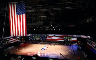 1262822765 LAKE BUENA VISTA, FLORIDA - JULY 30: The America flag is seen as the Los Angeles Lakers and the LA Clippers wear Black Lives Matter shirt and kneel during the national anthem prior to the game against the LA Clippers at The Arena at ESPN Wide World Of Sports Complex on July 30, 2020 in Lake Buena Vista, Florida. NOTE TO USER: User expressly acknowledges and agrees that, by downloading and or using this photograph, User is consenting to the terms and conditions of the Getty Images License Agreement. (Photo by Mike Ehrmann/Getty Images)