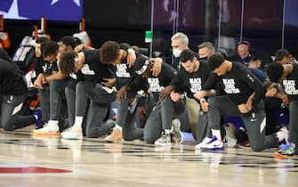 Orlando, FL - JULY 30: The New Orleans Pelicans and the Utah Jazz kneel for the National Anthem prior to a game on July 30, 2020 at HP Field House at ESPN Wide World of Sports in Orlando, Florida. NOTE TO USER: User expressly acknowledges and agrees that, by downloading and/or using this Photograph, user is consenting to the terms and conditions of the Getty Images License Agreement. Mandatory Copyright Notice: Copyright 2020 NBAE (Photo by David Sherman/NBAE via Getty Images)