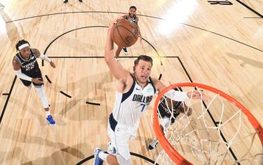 Orlando, FL - AUGUST 4: Luka Doncic #77 of the Dallas Mavericks goes up for a dunk against the Sacramento Kings on August 4, 2020 at The Arena at ESPN Wide World of Sports in Orlando, Florida. NOTE TO USER: User expressly acknowledges and agrees that, by downloading and/or using this Photograph, user is consenting to the terms and conditions of the Getty Images License Agreement. Mandatory Copyright Notice: Copyright 2020 NBAE (Photo by Garrett Ellwood/NBAE via Getty Images)