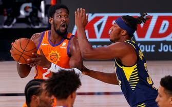 LAKE BUENA VISTA, FLORIDA - AUGUST 06: Deandre Ayton #22 of the Phoenix Suns drives to the basket as Myles Turner #33 of the Indiana Pacers defends at Visa Athletic Center at ESPN Wide World Of Sports Complex on August 06, 2020 in Lake Buena Vista, Florida. NOTE TO USER: User expressly acknowledges and agrees that, by downloading and or using this photograph, User is consenting to the terms and conditions of the Getty Images License Agreement. (Photo by Kevin C. Cox/Getty Images)