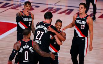 LAKE BUENA VISTA, FLORIDA - AUGUST 06: CJ McCollum #3 of the Portland Trail Blazers and Jusuf Nurkic #27 of the Portland Trail Blazers celebrate their 125-115 win over the Denver Nuggets at Visa Athletic Center at ESPN Wide World Of Sports Complex on August 06, 2020 in Lake Buena Vista, Florida. NOTE TO USER: User expressly acknowledges and agrees that, by downloading and or using this photograph, User is consenting to the terms and conditions of the Getty Images License Agreement. (Photo by Kevin C. Cox/Getty Images)