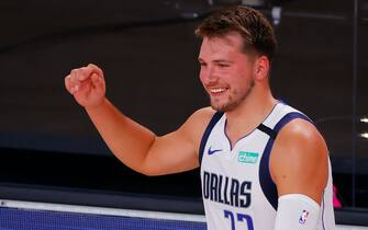 LAKE BUENA VISTA, FLORIDA - AUGUST 08: Luka Doncic #77 of the Dallas Mavericks smiles as he comes off the bench against the Milwaukee Bucks at The Arena at ESPN Wide World Of Sports Complex on August 08, 2020 in Lake Buena Vista, Florida. NOTE TO USER: User expressly acknowledges and agrees that, by downloading and or using this photograph, User is consenting to the terms and conditions of the Getty Images License Agreement. (Photo by Kevin C. Cox/Getty Images)