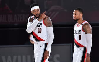 Orlando, FL - AUGUST 9: Carmelo Anthony #00 of the Portland Trail Blazers and Damian Lillard #0 of the Portland Trail Blazers look on during a game against the Philadelphia 76ers on August 9, 2020 at Visa Athletic Center at ESPN Wide World of Sports in Orlando, Florida. NOTE TO USER: User expressly acknowledges and agrees that, by downloading and/or using this Photograph, user is consenting to the terms and conditions of the Getty Images License Agreement. Mandatory Copyright Notice: Copyright 2020 NBAE (Photo by Jesse D. Garrabrant/NBAE via Getty Images)