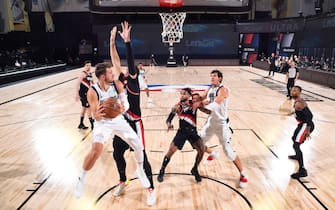 Orlando, FL - AUGUST 11: Luka Doncic #77 of the Dallas Mavericks looks to pass the ball against the Portland Trail Blazers on August 11, 2020 at The Field House in Orlando, Florida. NOTE TO USER: User expressly acknowledges and agrees that, by downloading and/or using this Photograph, user is consenting to the terms and conditions of the Getty Images License Agreement. Mandatory Copyright Notice: Copyright 2020 NBAE (Photo by Garrett Ellwood/NBAE via Getty Images)