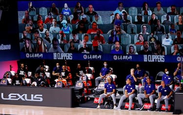 LAKE BUENA VISTA, FLORIDA - AUGUST 04: A view of the LA Clippers bench and fans on a screen during the game against the Phoenix Suns at The Arena at ESPN Wide World Of Sports Complex on August 04, 2020 in Lake Buena Vista, Florida. NOTE TO USER: User expressly acknowledges and agrees that, by downloading and or using this photograph, User is consenting to the terms and conditions of the Getty Images License Agreement.  (Photo by Kevin C. Cox/Getty Images)