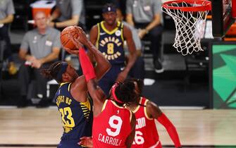 LAKE BUENA VISTA, FLORIDA - AUGUST 12:  Myles Turner #33 of the Indiana Pacers shoots against DeMarre Carroll #9 of the Houston Rockets in the fourth quarter at AdventHealth Arena at ESPN Wide World Of Sports Complex on August 12, 2020 in Lake Buena Vista, Florida. NOTE TO USER: User expressly acknowledges and agrees that, by downloading and or using this photograph, User is consenting to the terms and conditions of the Getty Images License Agreement.  (Photo by Kim Klement-Pool/Getty Images)
