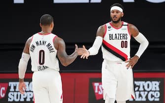 Orlando, FL - AUGUST 13: Damian Lillard #0 of the Portland Trail Blazers and Carmelo Anthony #00 of the Portland Trail Blazers high-five during a game against the Brooklyn Nets on August 13, 2020 at the AdventHealth Arena at in Orlando, Florida. NOTE TO USER: User expressly acknowledges and agrees that, by downloading and/or using this Photograph, user is consenting to the terms and conditions of the Getty Images License Agreement. Mandatory Copyright Notice: Copyright 2020 NBAE (Photo by Jesse D. Garrabrant/NBAE via Getty Images)