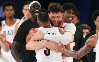 Orlando, FL - JULY 31: CJ McCollum #3 and Jusuf Nurkic #27 of the Portland Trail Blazers hug after winning a game against the Memphis Grizzlies on July 31, 2020 at The Arena at ESPN Wide World of Sports in Orlando, Florida. NOTE TO USER: User expressly acknowledges and agrees that, by downloading and/or using this Photograph, user is consenting to the terms and conditions of the Getty Images License Agreement. Mandatory Copyright Notice: Copyright 2020 NBAE (Photo by Joe Murphy/NBAE via Getty Images)