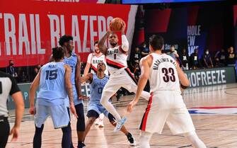 1227862174 Orlando, FL - JULY 31: Damian Lillard #0 of the Portland Trail Blazers passes the ball against the Memphis Grizzlies on July 31, 2020 at The Arena at ESPN Wide World Of Sports Complex in Orlando, Florida. NOTE TO USER: User expressly acknowledges and agrees that, by downloading and/or using this Photograph, user is consenting to the terms and conditions of the Getty Images License Agreement. Mandatory Copyright Notice: Copyright 2020 NBAE (Photo by Jesse D. Garrabrant/NBAE via Getty Images)