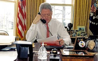 American politician US President Bill Clinton speaks on the telephone in the White House's Oval Office, Washington DC, February 27, 1997. He was speaking to Russian President Boris Yeltsin. (Photo by Ralph Alswang/White House/Consolidated News Pictures/Getty Images)