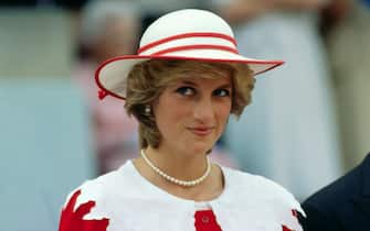 Diana, Princess of Wales, wears an outfit in the colors of Canada during a state visit to Edmonton, Alberta, with her husband.