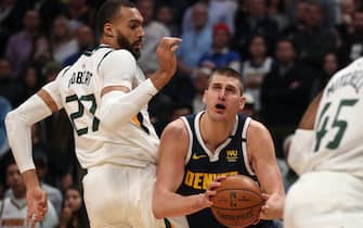 1203107094 DENVER, COLORADO - JANUARY 30: Nikola Jokic #15 of the Denver Nuggets goes to the basket against Rudy Gobert #27 of the Utah Jazz in the first quarter at the Pepsi Center on January 30, 2020 in Denver, Colorado. NOTE TO USER: User expressly acknowledges and agrees that, by downloading and or using this photograph, User is consenting to the terms and conditions of the Getty Images License Agreement. (Photo by Matthew Stockman/Getty Images)