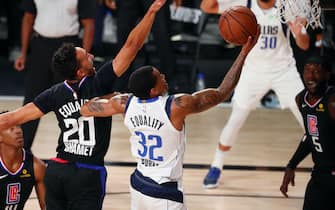 Aug 19, 2020; Lake Buena Vista, Florida, USA; Dallas Mavericks guard Trey Burke (32) scores against LA Clippers guard Landry Shamet (20) during the second half in game two of the first round of the 2020 NBA Playoffs at AdventHealth Arena. Mandatory Credit: Kim Klement-USA TODAY Sports