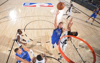 ORLANDO, FL - AUGUST 21: Luka Doncic #77 of the Dallas Mavericks shoots the ball against the LA Clippers during Round One, Game Three of the NBA Playoffs on August 21, 2020 at the AdventHealth Arena at ESPN Wide World Of Sports Complex in Orlando, Florida. NOTE TO USER: User expressly acknowledges and agrees that, by downloading and/or using this Photograph, user is consenting to the terms and conditions of the Getty Images License Agreement. Mandatory Copyright Notice: Copyright 2020 NBAE (Photo by Garrett Ellwood/NBAE via Getty Images)