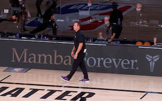 LAKE BUENA VISTA, FLORIDA - AUGUST 24: Frank Vogel of the Los Angeles Lakers looks on with Mamba Forever signage in the background honoring Kobe Bryant during the fourth quarter against the Portland Trail Blazers in Game Four of the Western Conference First Round during the 2020 NBA Playoffs at AdventHealth Arena at ESPN Wide World Of Sports Complex on August 24, 2020 in Lake Buena Vista, Florida. NOTE TO USER: User expressly acknowledges and agrees that, by downloading and or using this photograph, User is consenting to the terms and conditions of the Getty Images License Agreement. (Photo by Kevin C. Cox/Getty Images)