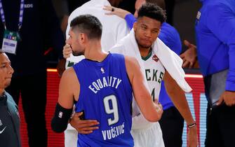 LAKE BUENA VISTA, FLORIDA - AUGUST 29: Giannis Antetokounmpo #34 of the Milwaukee Bucks hugs Nikola Vucevic #9 of the Orlando Magic following Game Five of the Eastern Conference First Round during the 2020 NBA Playoffs at AdventHealth Arena at ESPN Wide World Of Sports Complex on August 29, 2020 in Lake Buena Vista, Florida. NOTE TO USER: User expressly acknowledges and agrees that, by downloading and or using this photograph, User is consenting to the terms and conditions of the Getty Images License Agreement.  (Photo by Kevin C. Cox/Getty Images)