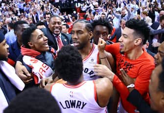 TORONTO, ON - MAY 12:  Kawhi Leonard #2 of the Toronto Raptors celebrates with teammates after sinking a buzzer beater to win Game Seven of the second round of the 2019 NBA Playoffs against the Philadelphia 76ers at Scotiabank Arena on May 12, 2019 in Toronto, Canada.  NOTE TO USER: User expressly acknowledges and agrees that, by downloading and or using this photograph, User is consenting to the terms and conditions of the Getty Images License Agreement.  (Photo by Vaughn Ridley/Getty Images)