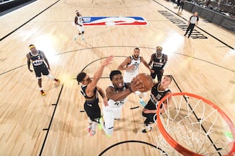 Orlando, FL - AUGUST 17: Donovan Mitchell #45 of the Utah Jazz shoots the ball against the Denver Nuggets during Round One, Game One of the NBA Playoffs on August 17, 2020 in Orlando, Florida at The Field House. NOTE TO USER: User expressly acknowledges and agrees that, by downloading and/or using this Photograph, user is consenting to the terms and conditions of the Getty Images License Agreement. Mandatory Copyright Notice: Copyright 2020 NBAE (Photo by Garrett Ellwood/NBAE via Getty Images)