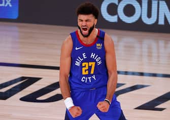 LAKE BUENA VISTA, FLORIDA - AUGUST 30: Jamal Murray #27 of the Denver Nuggets reacts after shooting a three point basket against the Utah Jazz during the fourth quarter in Game Six of the Western Conference First Round during the 2020 NBA Playoffs at AdventHealth Arena at ESPN Wide World Of Sports Complex on August 30, 2020 in Lake Buena Vista, Florida. NOTE TO USER: User expressly acknowledges and agrees that, by downloading and or using this photograph, User is consenting to the terms and conditions of the Getty Images License Agreement. (Photo by Kevin C. Cox/Getty Images)