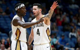 NEW ORLEANS, LOUISIANA - DECEMBER 15: Jrue Holiday #11 of the New Orleans Pelicans and JJ Redick #4 of the New Orleans Pelicans stand on the court during a NBA game against the Orlando Magic at Smoothie King Center on December 15, 2019 in New Orleans, Louisiana. NOTE TO USER: User expressly acknowledges and agrees that, by downloading and or using this photograph, User is consenting to the terms and conditions of the Getty Images License Agreement. (Photo by Sean Gardner/Getty Images)
