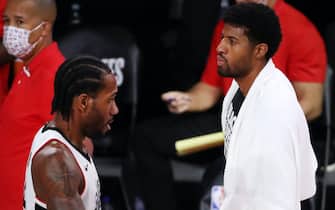 LAKE BUENA VISTA, FLORIDA - SEPTEMBER 13: Kawhi Leonard #2 of the LA Clippers and Paul George #13 of the LA Clippers react during the first quarter against the Denver Nuggets in Game Six of the Western Conference Second Round during the 2020 NBA Playoffs at AdventHealth Arena at the ESPN Wide World Of Sports Complex on September 12, 2020 in Lake Buena Vista, Florida. NOTE TO USER: User expressly acknowledges and agrees that, by downloading and or using this photograph, User is consenting to the terms and conditions of the Getty Images License Agreement. (Photo by Michael Reaves/Getty Images)