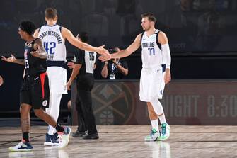 Orlando, FL - AUGUST 30: Maxi Kleber #42 and Luka Doncic #77 of the Dallas Mavericks hi-five during the game against the LA Clippers during Round One, Game Six of the NBA Playoffs on August 30, 2020 in Orlando, Florida at AdventHealth Arena. NOTE TO USER: User expressly acknowledges and agrees that, by downloading and/or using this Photograph, user is consenting to the terms and conditions of the Getty Images License Agreement. Mandatory Copyright Notice: Copyright 2020 NBAE (Photo by Andrew D. Bernstein/NBAE via Getty Images)