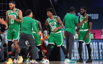 ORLANDO, FL - SEPTEMBER 19: Jayson Tatum #0 of the Boston Celtics, Marcus Smart #36 of the Boston Celtics, and Jaylen Brown #7 of the Boston Celtics high-five their teammates prior to a game against the Miami Heat during Game Two of the Eastern Conference Finals of the NBA Playoffs on September 19, 2020 at the AdventHealth Arena at ESPN Wide World Of Sports Complex in Orlando, Florida. NOTE TO USER: User expressly acknowledges and agrees that, by downloading and/or using this Photograph, user is consenting to the terms and conditions of the Getty Images License Agreement. Mandatory Copyright Notice: Copyright 2020 NBAE (Photo by Jesse D. Garrabrant/NBAE via Getty Images)