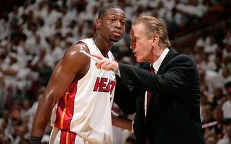 MIAMI - JUNE 15:  (L-R) Dwyane Wade #3 and head coach Pat Riley of the Miami Heat talk during a stop in play against the Dallas Mavericks during Game Four of the 2006 NBA Finals June 15, 2006 at American Airlines Arena in Miami, Florida. NOTE TO USER: User expressly acknowledges and agrees that, by downloading and or using this photograph, User is consenting to the terms and conditions of the Getty Images License Agreement. Mandatory Copyright Notice: Copyright 2006 NBAE (Photo by Nathaniel S. Butler/NBAE via Getty Images)