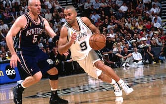 SAN ANTONIO - JUNE 4:  Tony Parker #9 of the San Antonio Spurs drives past Jason Kidd #5 of the New Jersey Nets during Game one of the 2003 NBA Finals at the SBC Center on June 4, 2003 in San Antonio, Texas.  The Spurs won 101-89.  NOTE TO USER: User expressly acknowledges and agrees that, by downloading and/or using this Photograph, User is consenting to the terms and conditions of the Getty Images License Agreement.  Copyright 2003 NBAE  (Photo by Andrew D. Bernstein/NBAE via Getty Images) 