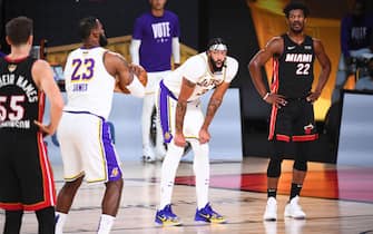 ORLANDO, FL - OCTOBER 4: Anthony Davis #3 of the Los Angeles Lakers and Jimmy Butler #22 of the Miami Heat look on while LeBron James #23 of the Los Angeles Lakers shoots a free throw during Game Three of the NBA Finals on October 4, 2020 at the AdventHealth Arena at ESPN Wide World Of Sports Complex in Orlando, Florida. NOTE TO USER: User expressly acknowledges and agrees that, by downloading and/or using this Photograph, user is consenting to the terms and conditions of the Getty Images License Agreement. Mandatory Copyright Notice: Copyright 2020 NBAE (Photo by Garrett Ellwood/NBAE via Getty Images)