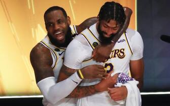 LAKE BUENA VISTA, FLORIDA - OCTOBER 11: LeBron James #23 of the Los Angeles Lakers and Anthony Davis #3 of the Los Angeles Lakers react after winning the 2020 NBA Championship in Game Six of the 2020 NBA Finals at AdventHealth Arena at the ESPN Wide World Of Sports Complex on October 11, 2020 in Lake Buena Vista, Florida. NOTE TO USER: User expressly acknowledges and agrees that, by downloading and or using this photograph, User is consenting to the terms and conditions of the Getty Images License Agreement.  (Photo by Mike Ehrmann/Getty Images)